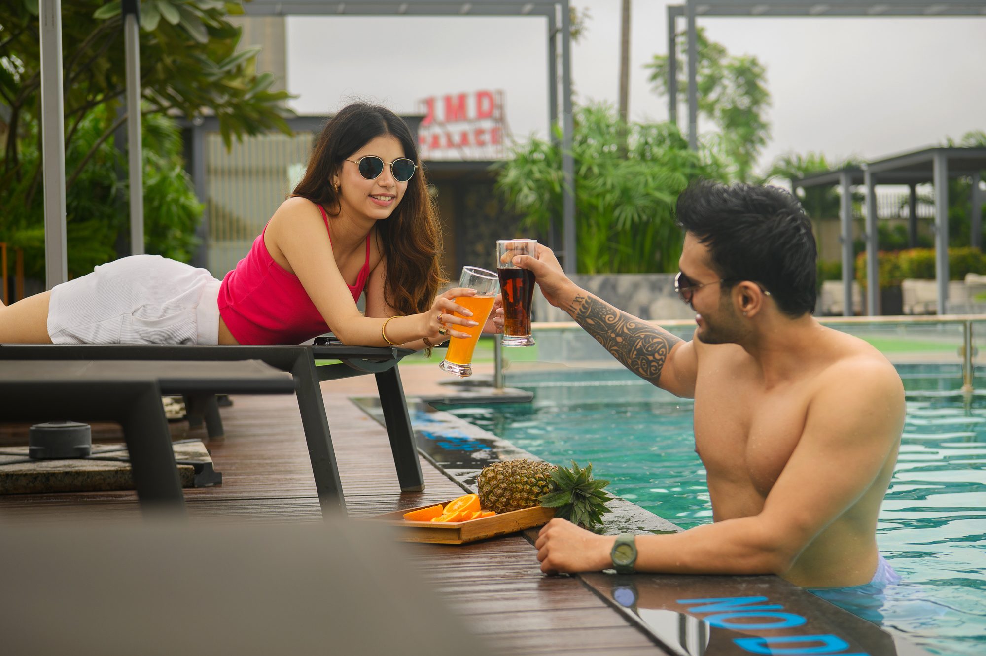 Guests toasting by the rooftop pool at JMD Palace